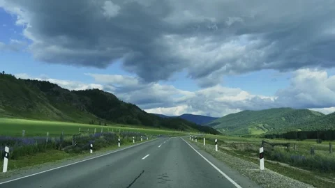 A road in a mountain valley among alpine meadows. 動画素材 311406181