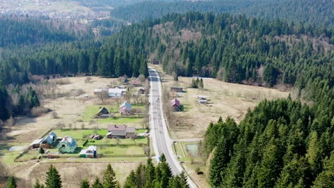 A road in a mountainous area. A group of cyclists is moving along the track Stock Footage 203850668