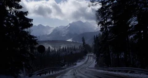 Road with mountains in background. Fast clouds shadowing sun. Stock Footage 147641705