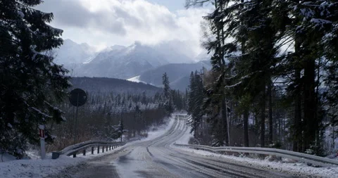 Road with mountains in background. Fast clouds shadowing sun. Stock Footage 147642030