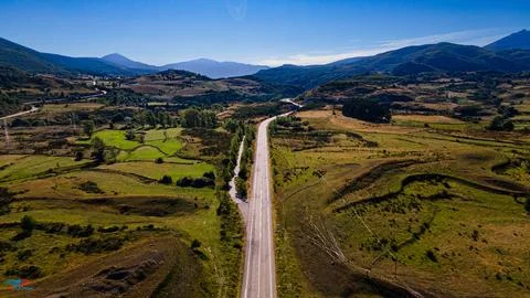 Road to the mountains from drone view. Stock Photos