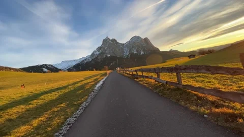 Road in the mountains illuminated by the sunset Video stock 232220755