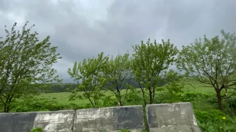 Road in Mountains. Low Clouds. Green Grass. View from the Car 02 Stock Footage 155619735