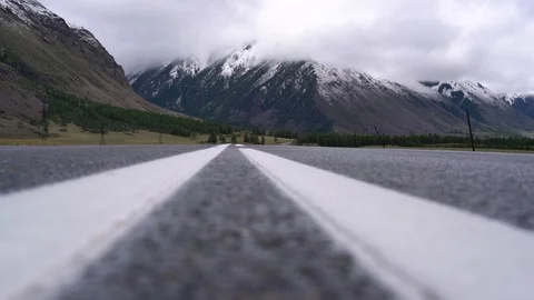 Road in the mountains, road view close-up, mountains and clouds 스톡 동영상 94029658