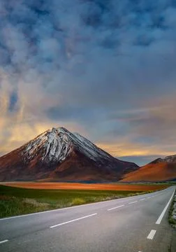 Road to the mountains under the clouds Stock Photos