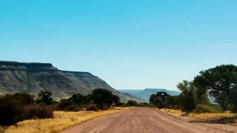 A road in Namibia on a clear, dry, sunny day	 Vídeo Stock 333107808