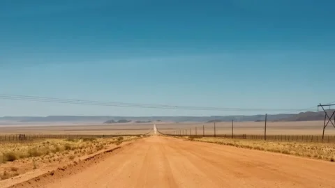 A road in Namibia on a clear, dry, sunny day	 Vídeos de archivo 333570047
