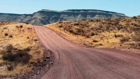 A road in Namibia on a clear, dry, sunny day	 Vídeos de archivo 333570080