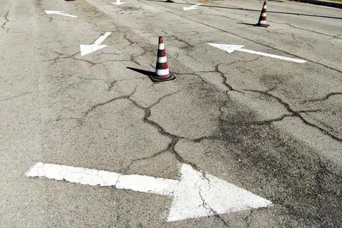 Road with painted with white pointers and traffic cones Stock Photos