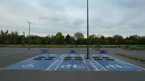 A road parking near a store. accessibility for wheelchair users Stock Footage 274635490