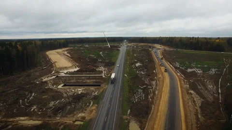 The road passing through the field in the forest. Moscow region road repair Stock Footage 97785616