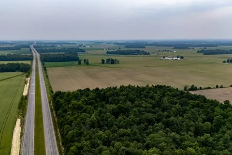 A road passing through a field. 스톡 사진