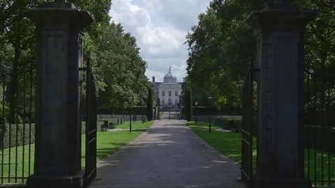 Road passing through an open gate Stock Footage 73701924