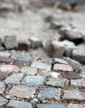 Road paved with cubic rock bricks under construction Stock Photos