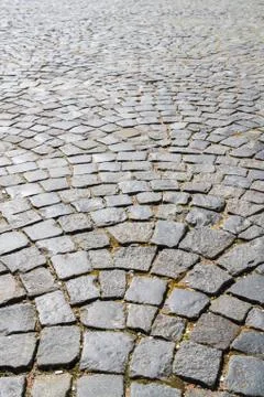 The road is paved with large stone Stock Photos