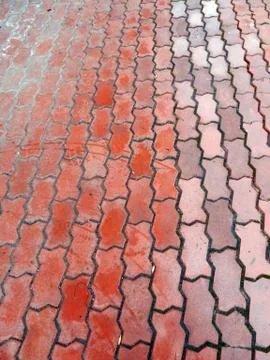 Road paved with red curly paving tiles Stock Photos