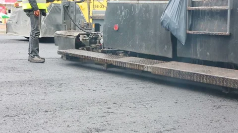 Road Paving. Workers laying stone mastic asphalt during street repairing work Video stock 65255897