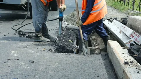 Road Paving. Workers laying stone mastic asphalt during street repairing work Stock Footage 65255948