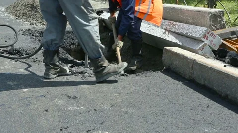 Road Paving. Workers laying stone mastic asphalt during street repairing work Stock Footage 65256498