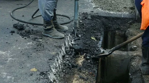Road Paving. Workers laying stone mastic asphalt during street repairing work Stock Footage 65256637