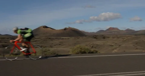 A Road Racing Cyclist Riding through Volcanos. Vídeos de archivo 79822089