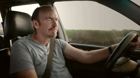 Road rage. Angry driver shouts and gestures at unseen vehicle on his right. Stock Footage 55664699