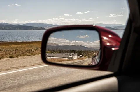 Road reflected in the side mirror of a moving ca Stock Photos