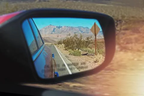 Road reflecting in the sideview mirror of a car Stock Photos