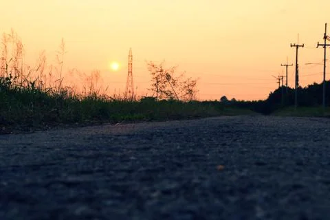 Road at the river on sunset Stock Photos