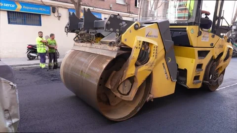 Road roller and compactor machine in action during asphalt paving 스톡 동영상 253230895