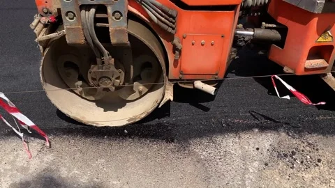 A road roller asphalts a road Stock Footage 240546851