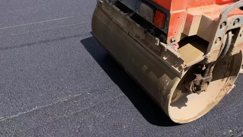 A road roller asphalts a street Stock Footage 240546870