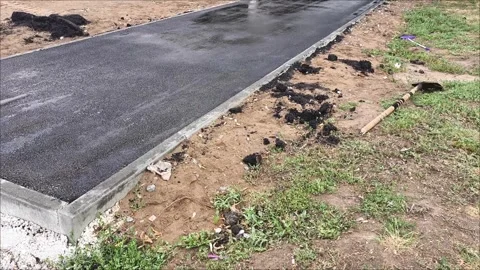 A road roller car rolls up hot asphalt on the road. Stock Footage 312249266