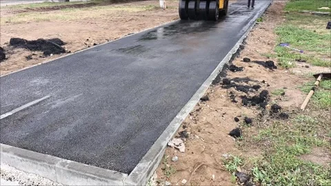 A road roller car rolls up hot asphalt on the road. Stock Footage 312249290