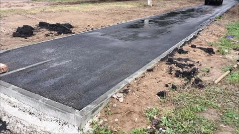 A road roller car rolls up hot asphalt on the road. 動画素材 312249310