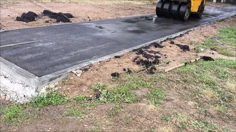 A road roller car rolls up hot asphalt on the road. 스톡 동영상 312249318