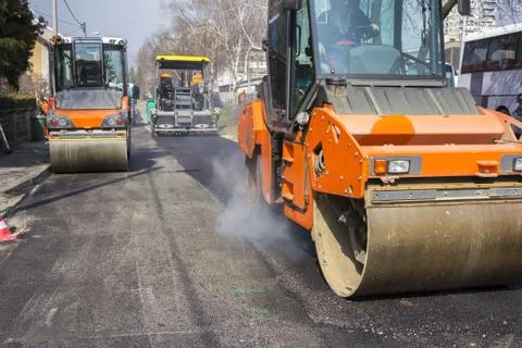 Road roller compacting asphalt Stock Photos