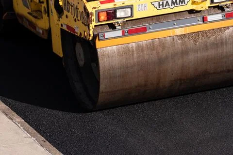 Road roller compacting fresh asphalt in Brooklyn Photos