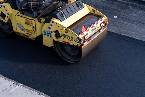 Road roller compacting fresh asphalt in Brooklyn Photos