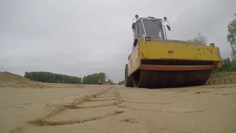 Road-roller compacting ground or compressing sand Stock Footage 158040552