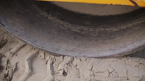 Road roller compacting soil surface close-up Stock Footage 310950648