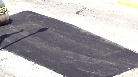 Road roller doing road repair and paving of streets, Video stock 81927138