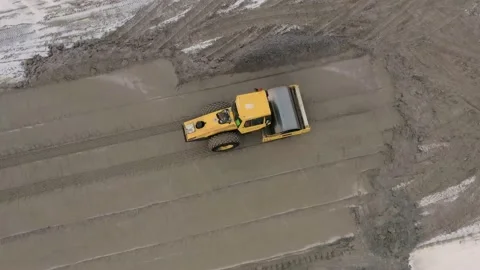A road roller is driving on a construction site. Stock Footage 154690560