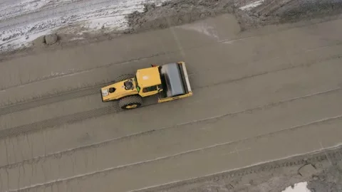 A road roller is driving on a construction site. Stock Footage 154941901