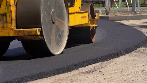 Road roller makes new road. Asphalt paver applying asphalt on a highway Stock Footage 169348297