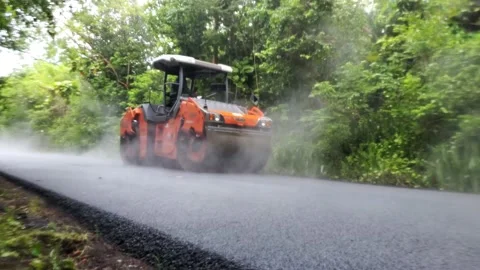 Road Roller Paving Asphalt on Rainy Day Stock Footage 219949538