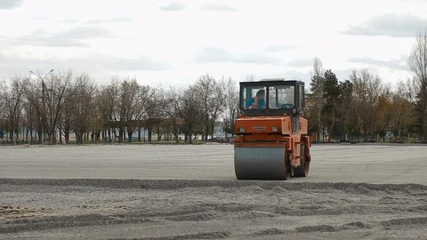 Road roller prepares the surface for the Stock Footage 128568583