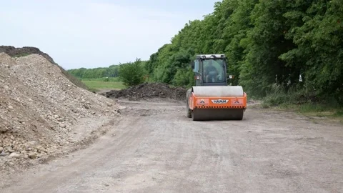 Road roller rides on construction site. Industrial. Russia, Stavropol, 10.06.20 Video stock 144243756