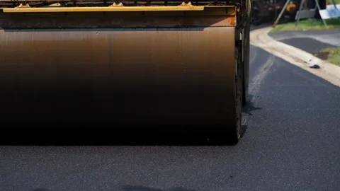 Road roller , steamroller in action, pressing down freshly laid asphalt on a Stock Footage 310285052