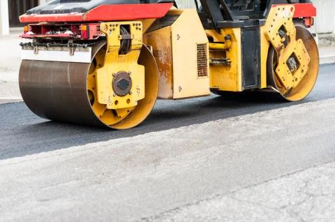 Road roller at work. Work of asphalting a road. Stock Photos